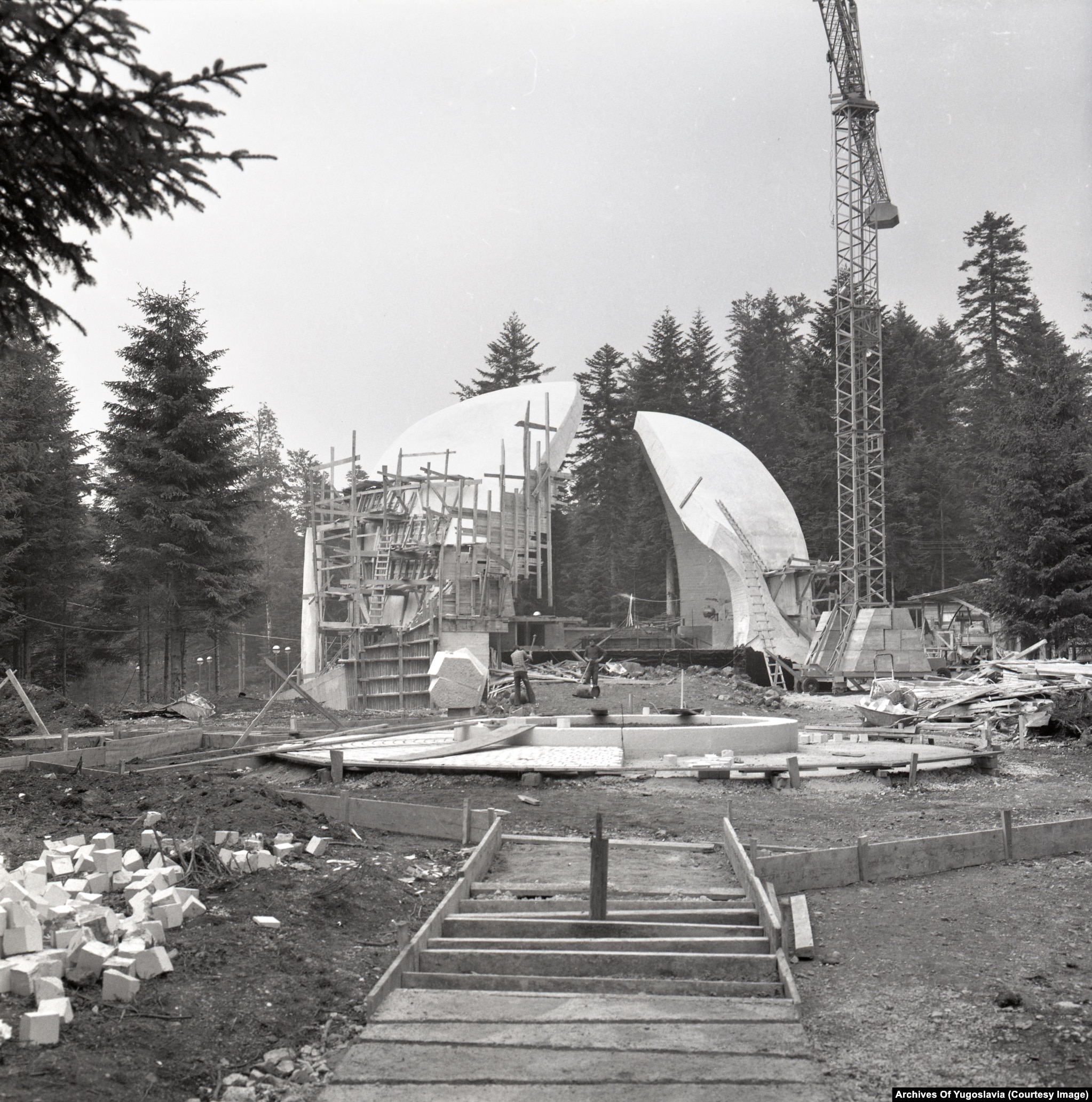 A biomorphic concrete shell monument set on a forested mountainside on Grmeč.