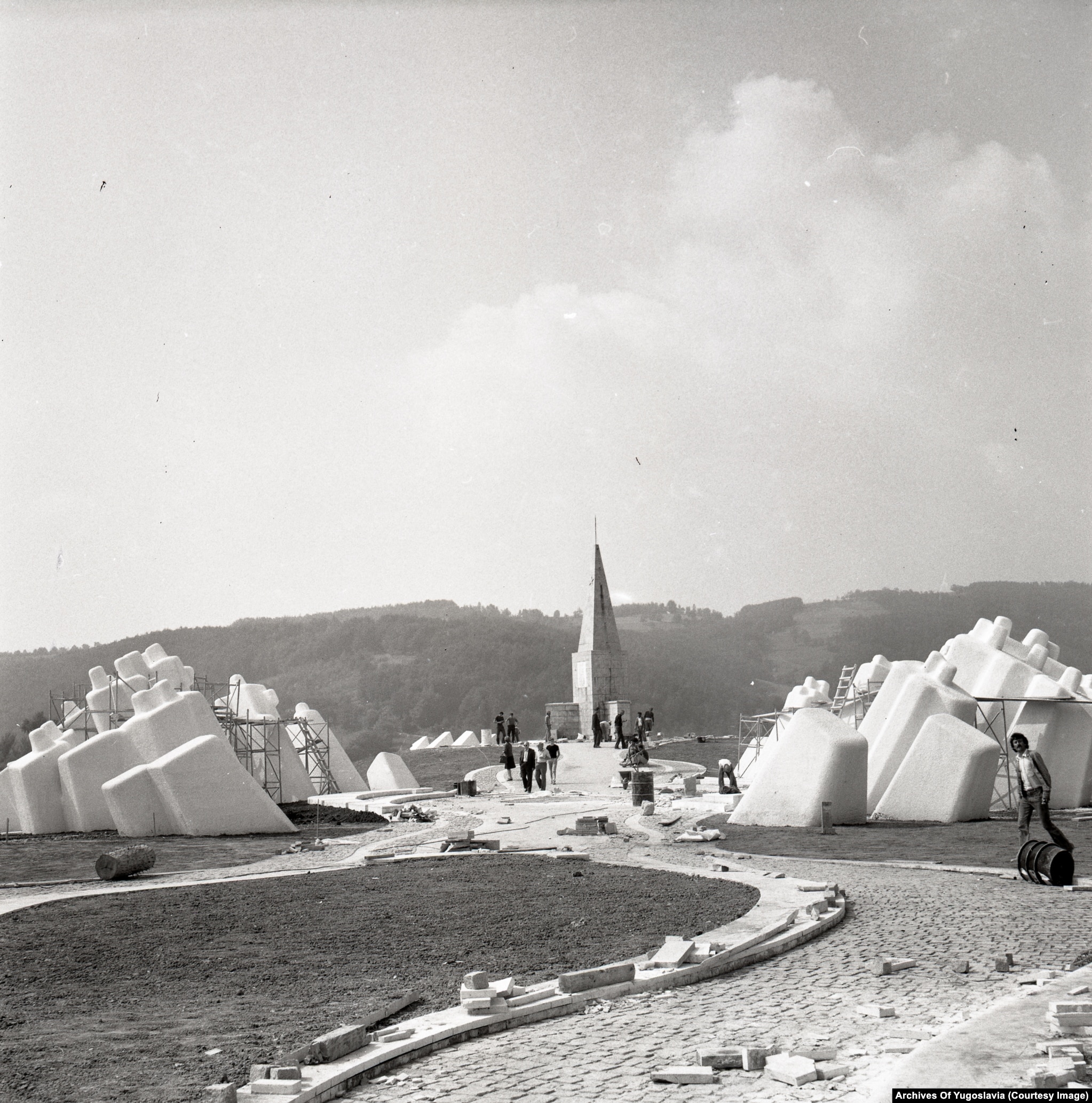 A slender, spire-like concrete structure rising from the Kadinjača memorial platform.